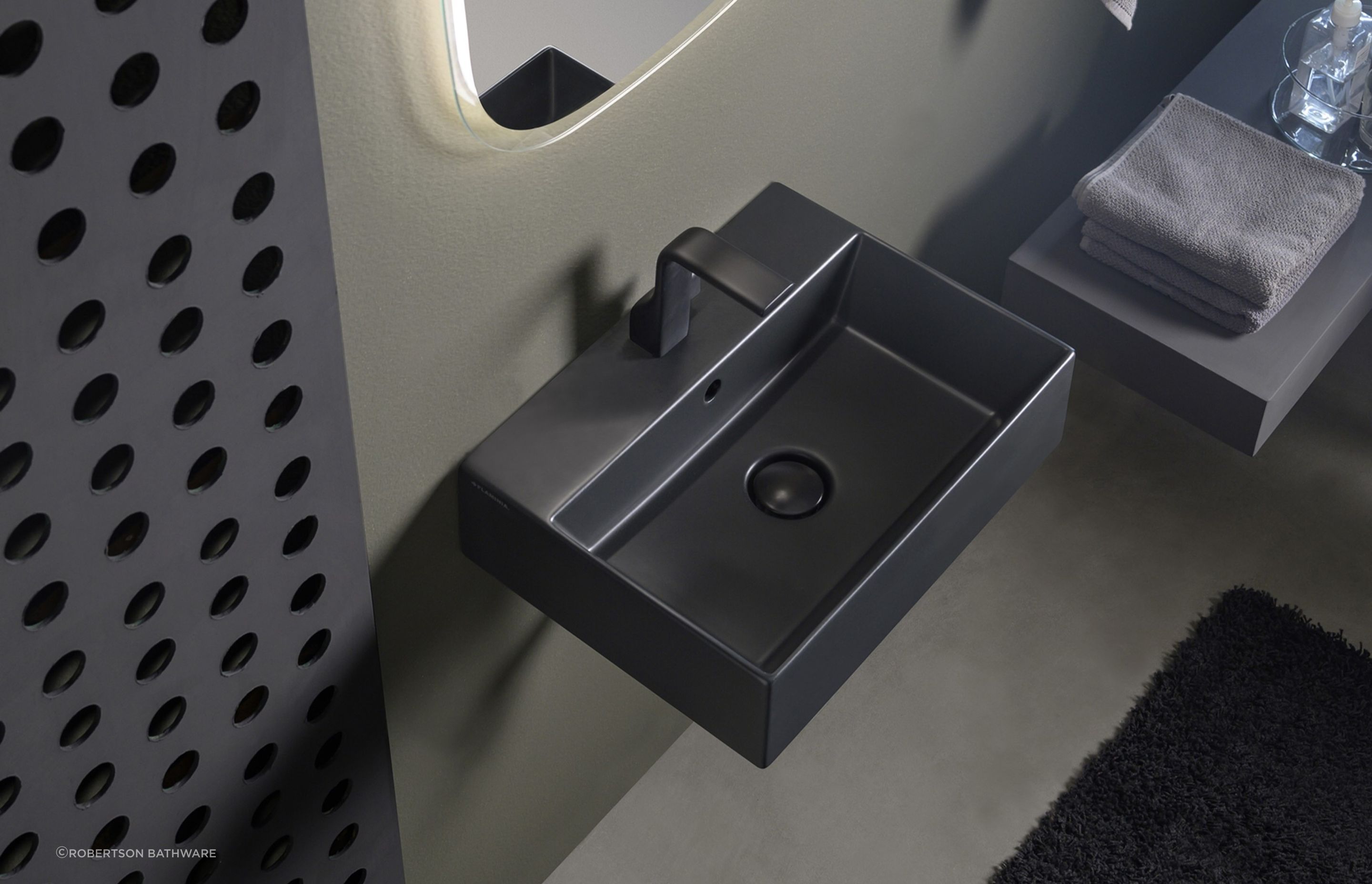 The App light vessel basin, seen here in a carbone finish, works in both residential and commercial settings.
