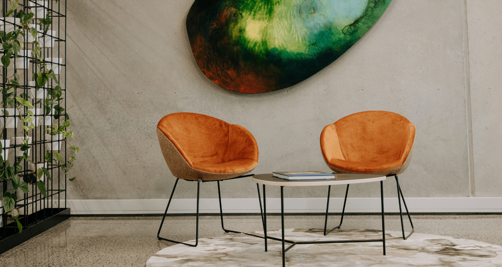 Amelia chairs and Divi coffee table with plant walls complement the client's artwork and rug carefully selected by interior designer Donna Jones.