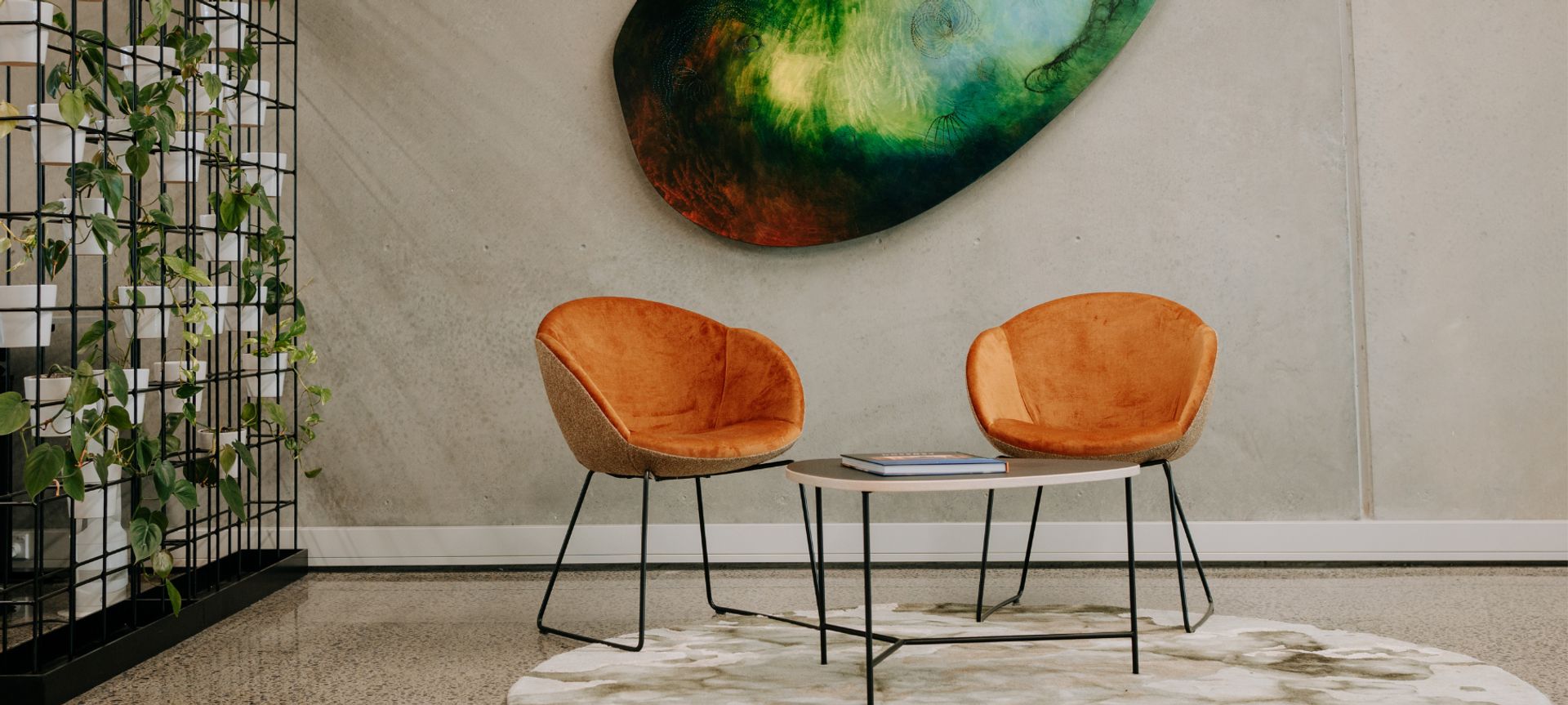 Amelia chairs and Divi coffee table with plant walls complement the client's artwork and rug carefully selected by interior designer Donna Jones.