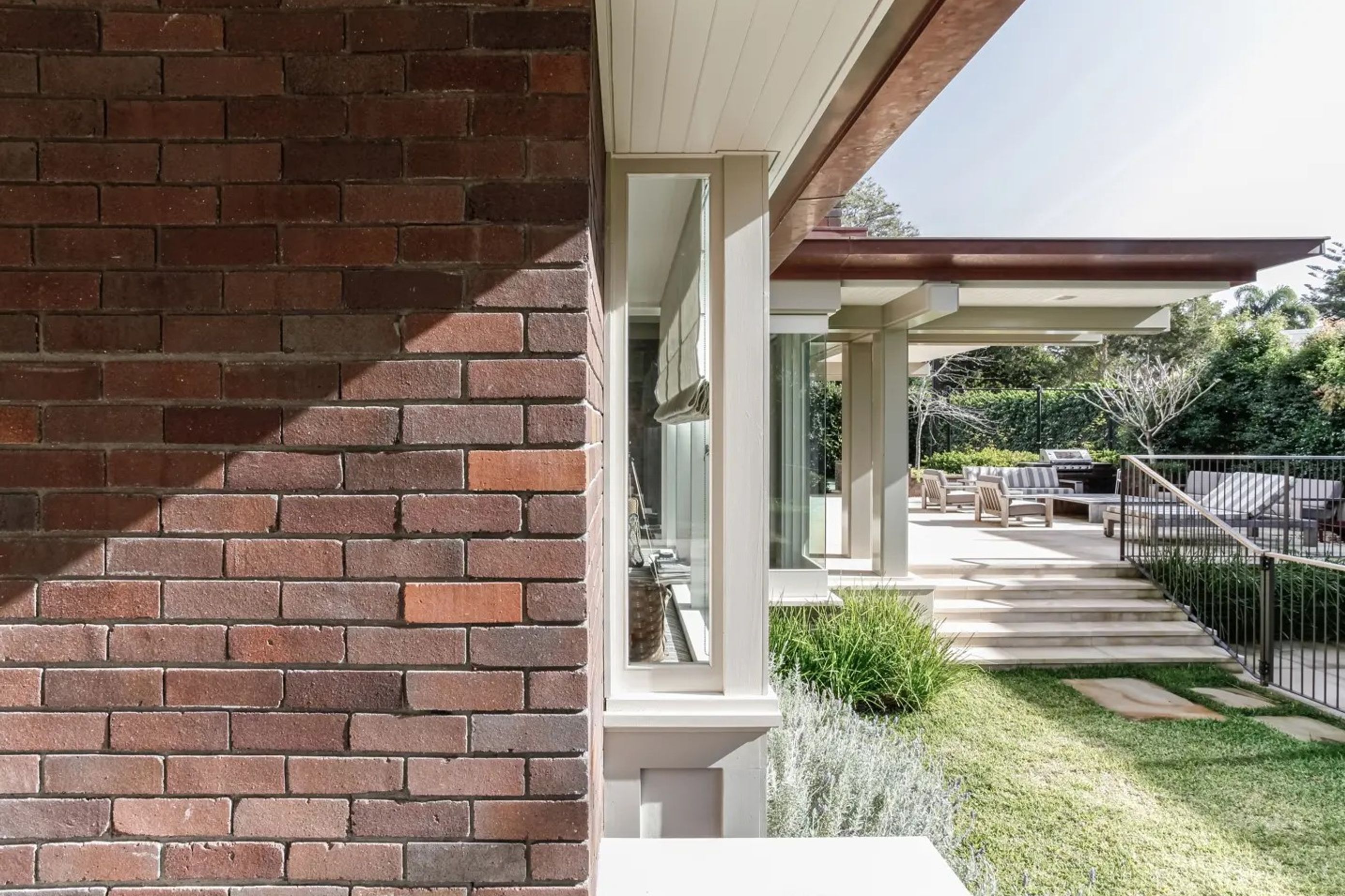 Wide terraces provide ample space for outdoor living around the exterior of the house - Photography: Lachlan Rowe