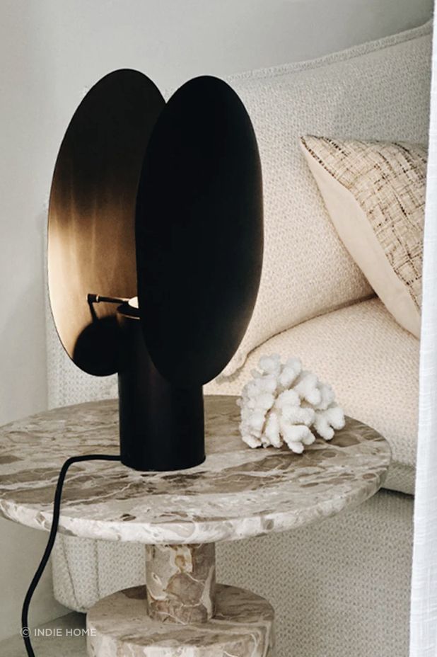 The Clam Table Lamp offers an entrancing interplay of light and shadow.