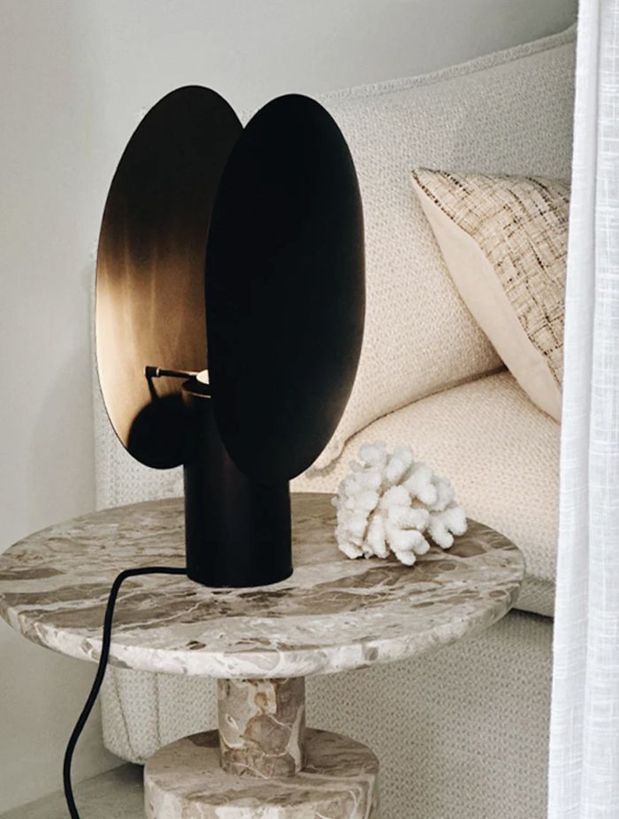 The Clam Table Lamp offers an entrancing interplay of light and shadow.