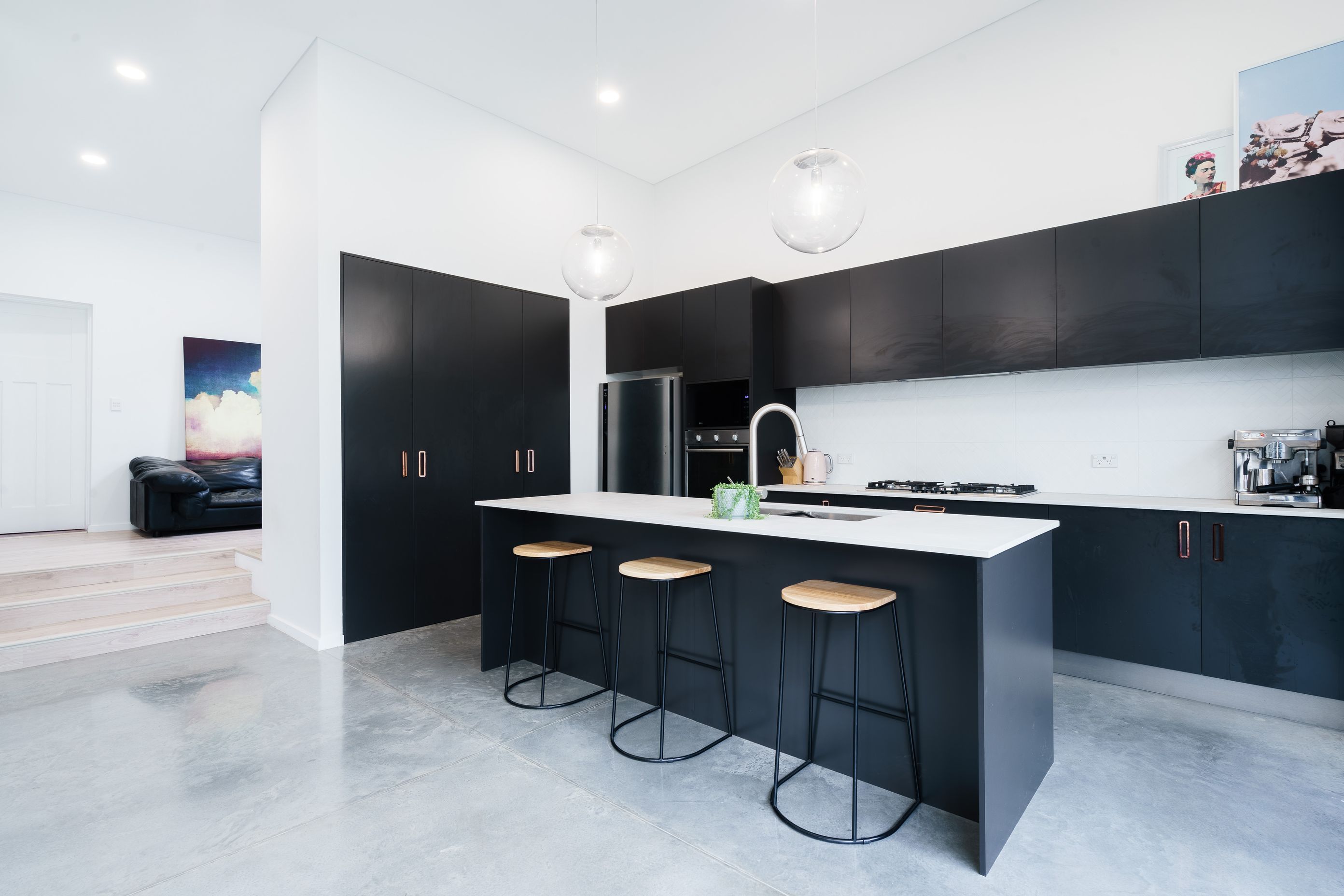 Dark &amp; concrete kitchen by JPC Kitchens