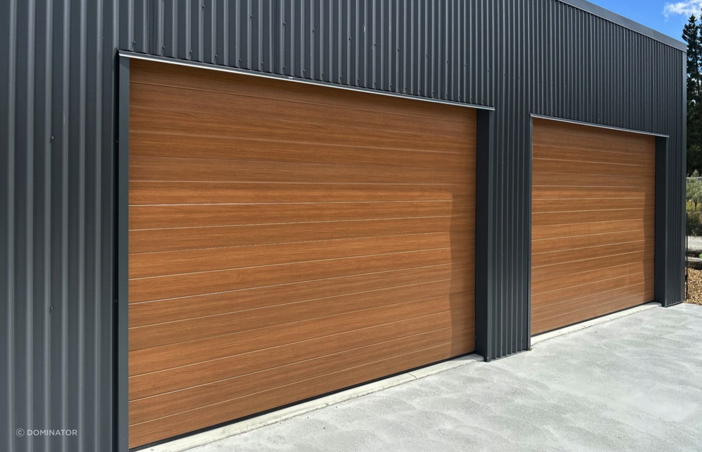 Dominator NatureSteel garage doors  are the perfect combination of beauty and strength. NatureSteel material mimics the look of natural timber, giving your garage a sophisticated finish that will elevate the overall aesthetic of your property.
