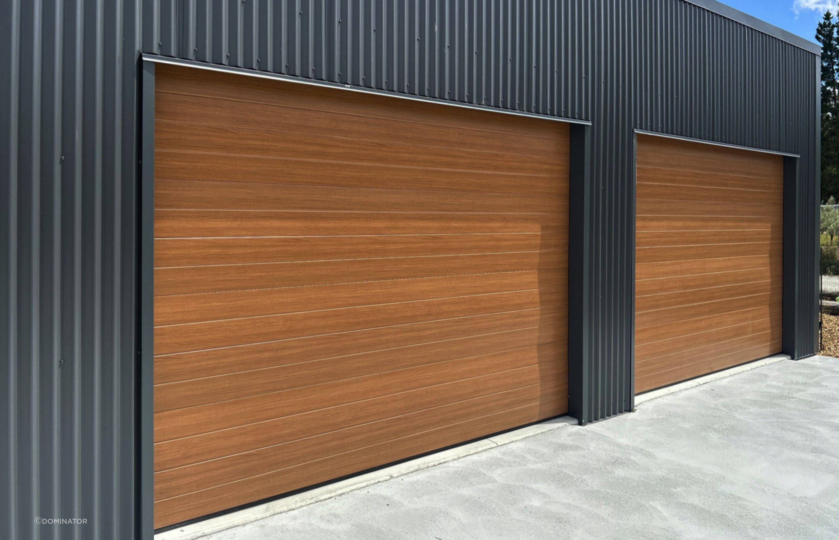 Dominator NatureSteel garage doors  are the perfect combination of beauty and strength. NatureSteel material mimics the look of natural timber, giving your garage a sophisticated finish that will elevate the overall aesthetic of your property.