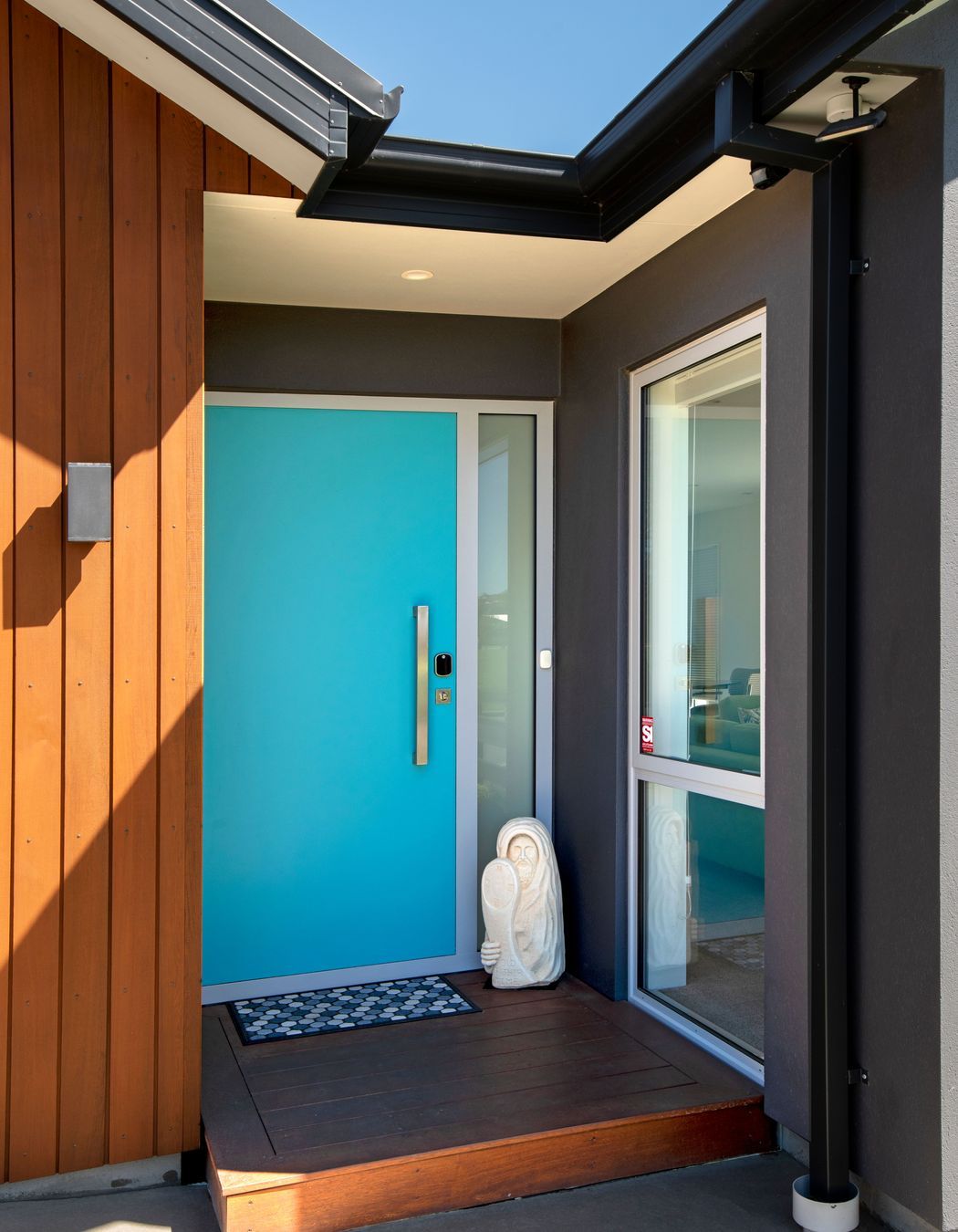 A single panel composite door becomes a feature in bright turquoise blue.