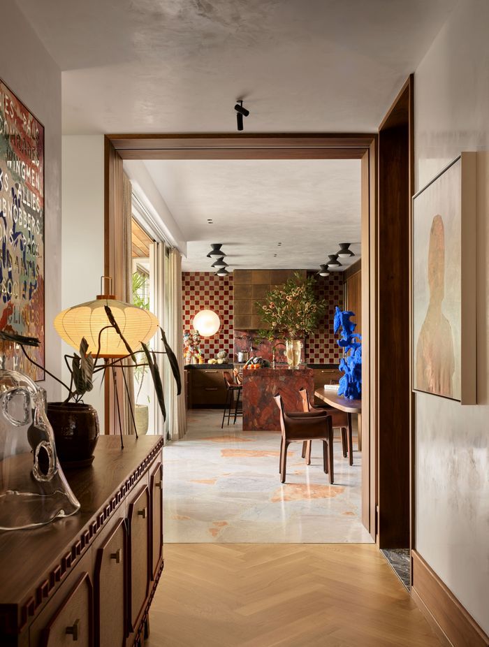 A colourful and artful interior is elevated with a soft plaster finish on both walls and ceiling.