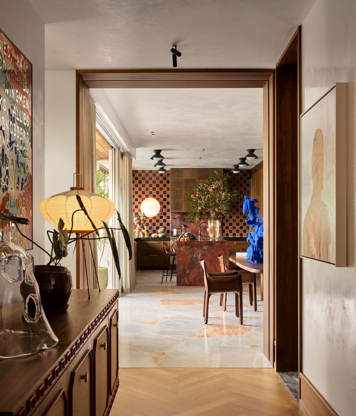 A colourful and artful interior is elevated with a soft plaster finish on both walls and ceiling.