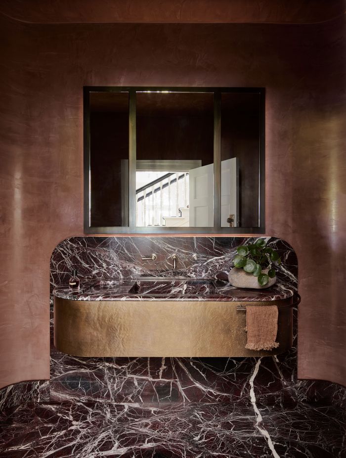 The bathroom is a great place to add texture. This bathroom features a terracotta plaster finish that enhances the tones in the stone floor and vanity.