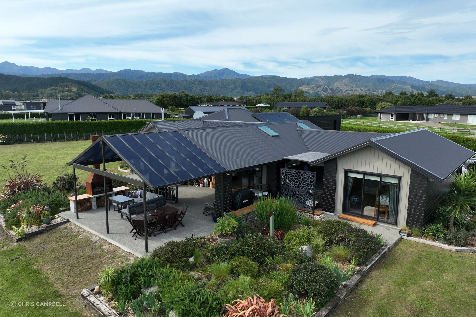 “The home has a gable roof that covers a smaller outdoor living space; as the clients wanted to extend that living area, they were looking for a gable canopy that would flow with the existing roof line.”