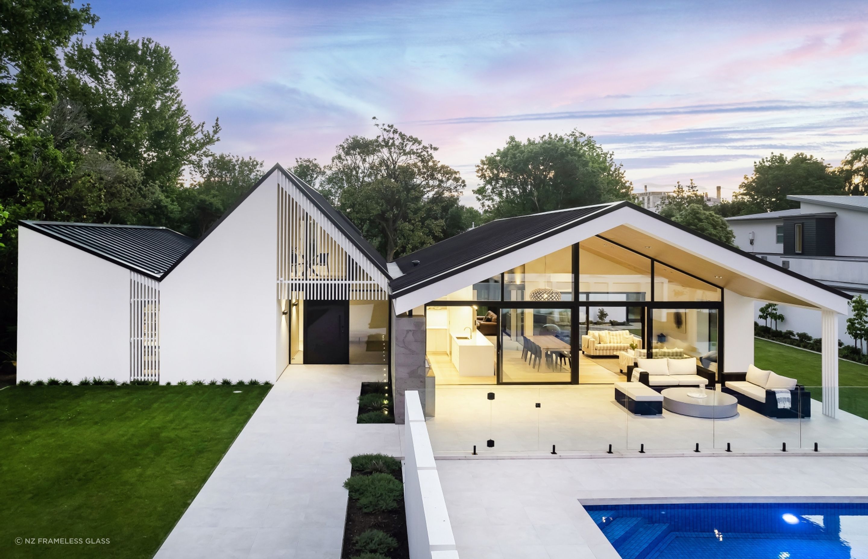 A stylish pool fence by NZ Frameless Glass showing how exquisite glass pool fences can be.