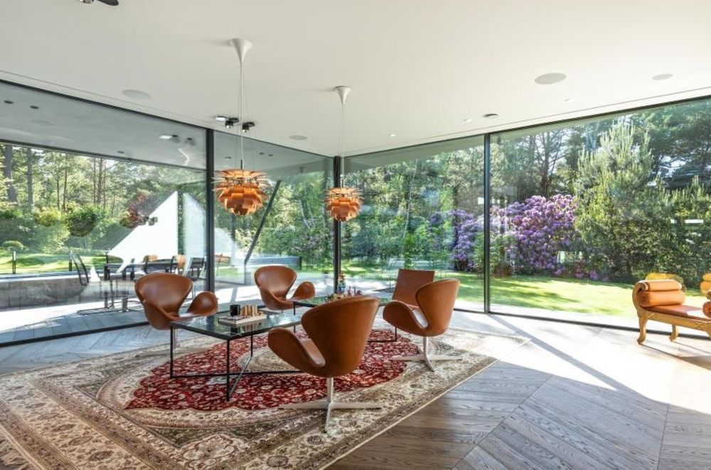 This Sweden home's window and door system is by Grupo Sosoares - Portugal and uses an OS double and OS triple minimalist sliding system. Architecture by Realestelligenece (part of Investelligence Group).