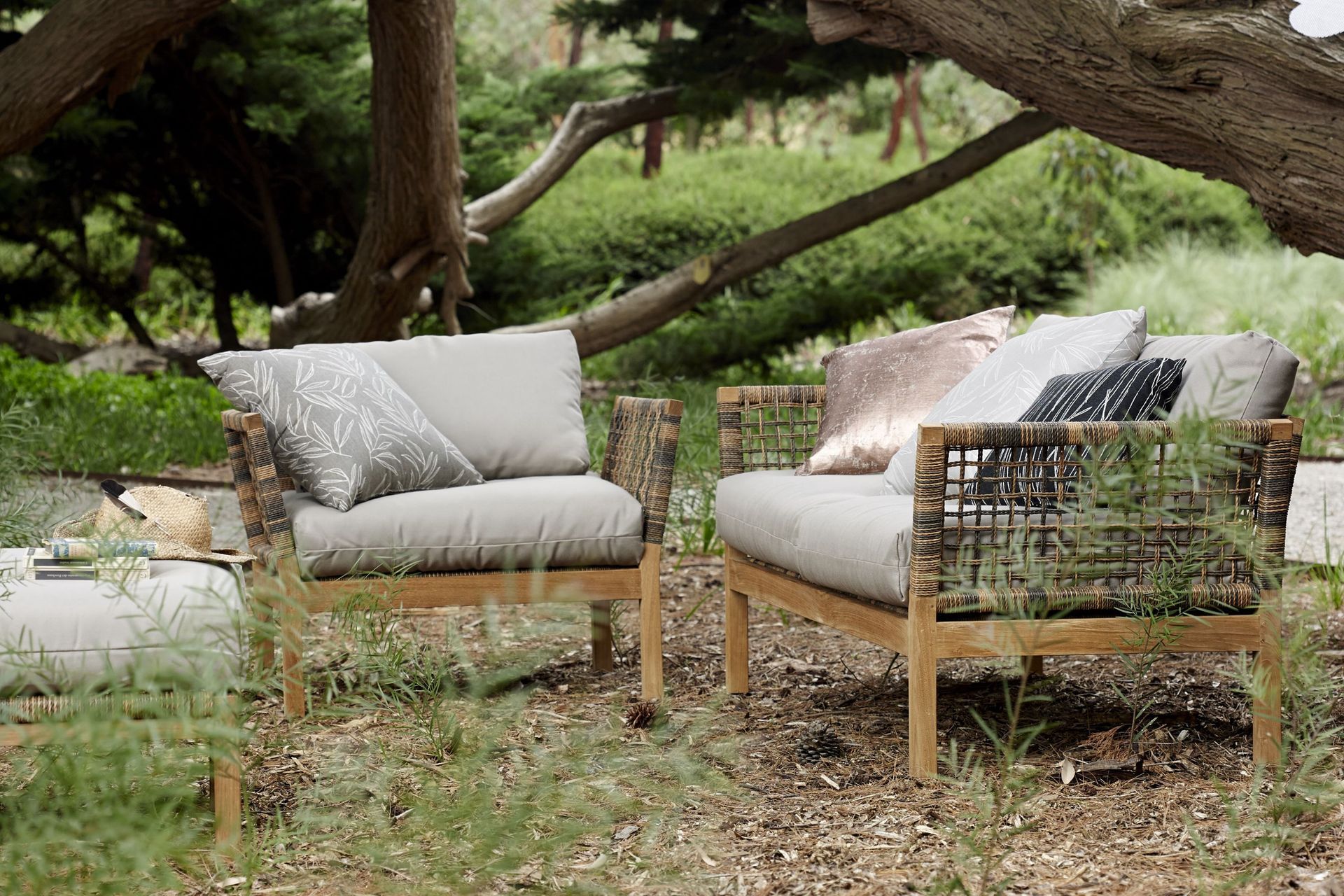 The Hutt Outdoor Lounge Armchair features a teak frame and thick open rope weave, naturally blending into a wide variety of environments.