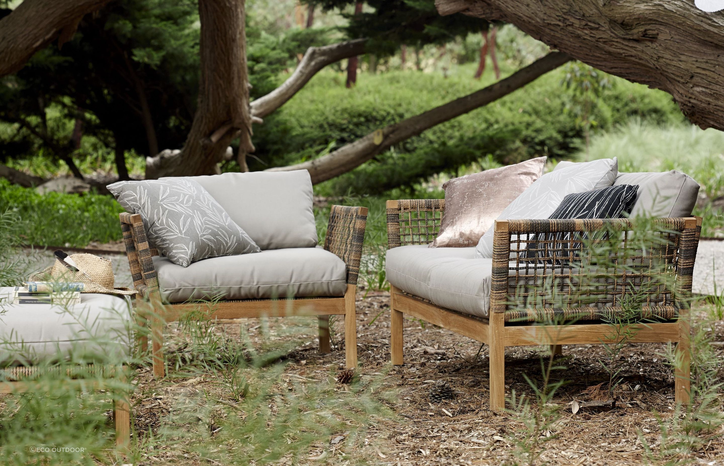 The Hutt Outdoor Lounge Armchair features a teak frame and thick open rope weave, naturally blending into a wide variety of environments.