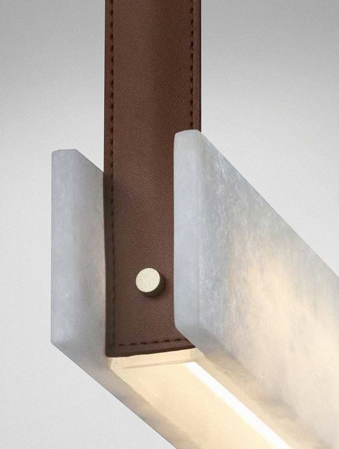 Look for feature lighting with special details such as the affordable Slate linear pendant featuring stone, brass and leather from ilonka lighting.