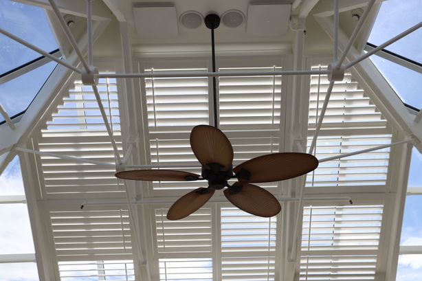 Motorised shutters provide shading and heat control in this glass atrium, and complement the architecture of this circa 1800s club.
