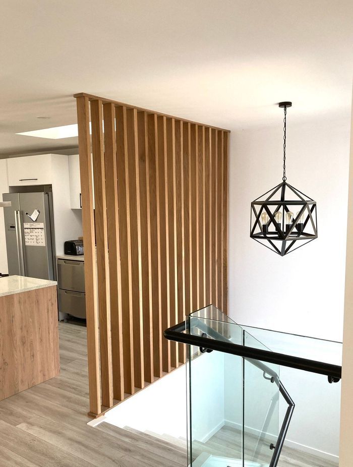 This timber feature wall creates visual separation without closing off the space.