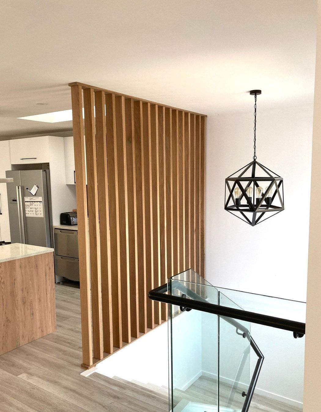 This timber feature wall creates visual separation without closing off the space.