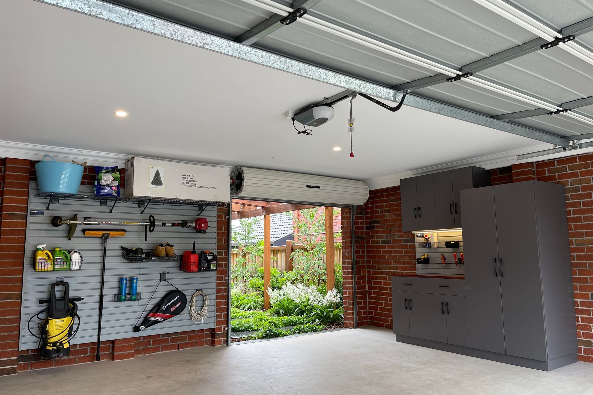 The SmartWall system by GarageSmart comes with interchangeable hooks, racks and baskets.