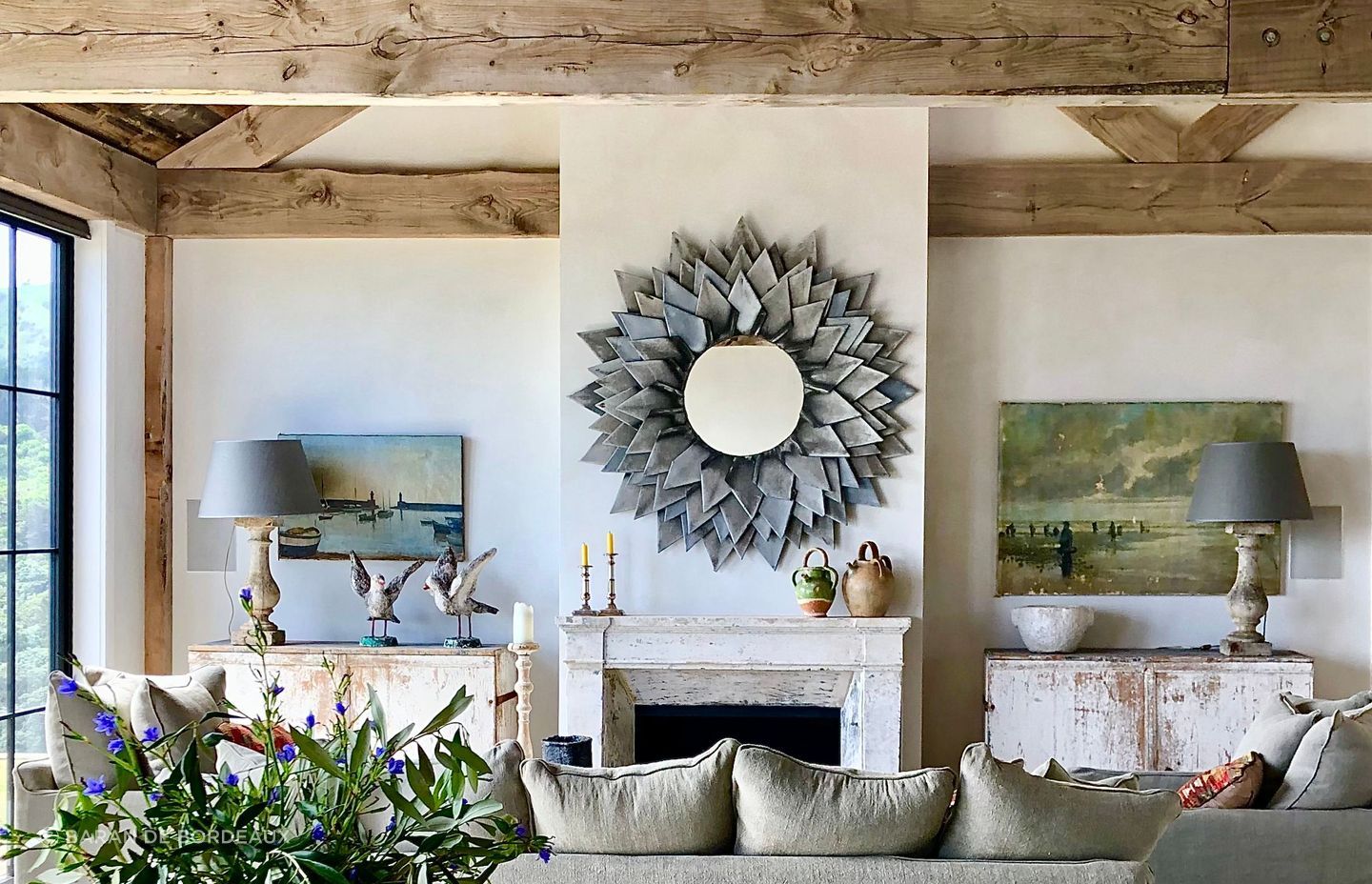 This layered interior makes subtle nods to the seaside through artwork and distressed antique sideboards. All items from Baran de Bordeaux.
