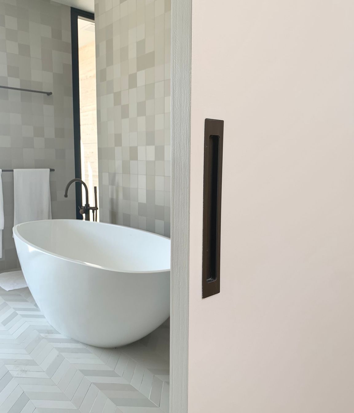 A flush pull handle adds clean lines to the bathroom sliding door