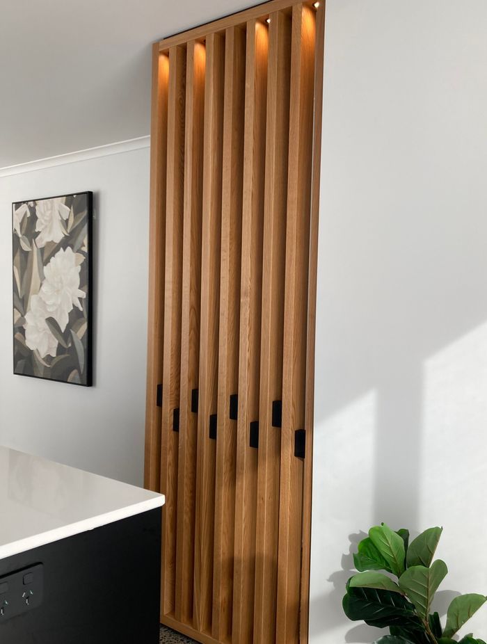 This American oak feature wall has been fitted with down lights to add an element of drama to the space.