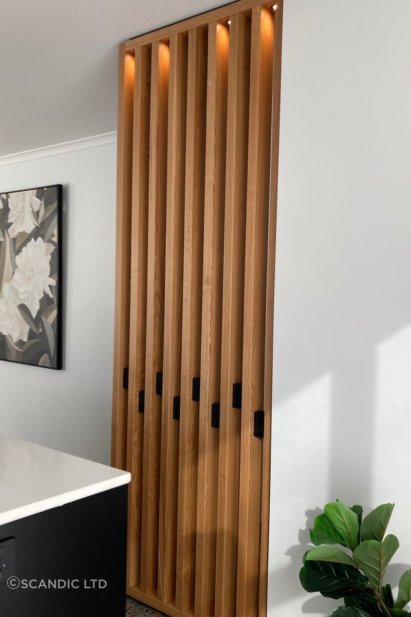 This American oak feature wall has been fitted with down lights to add an element of drama to the space.