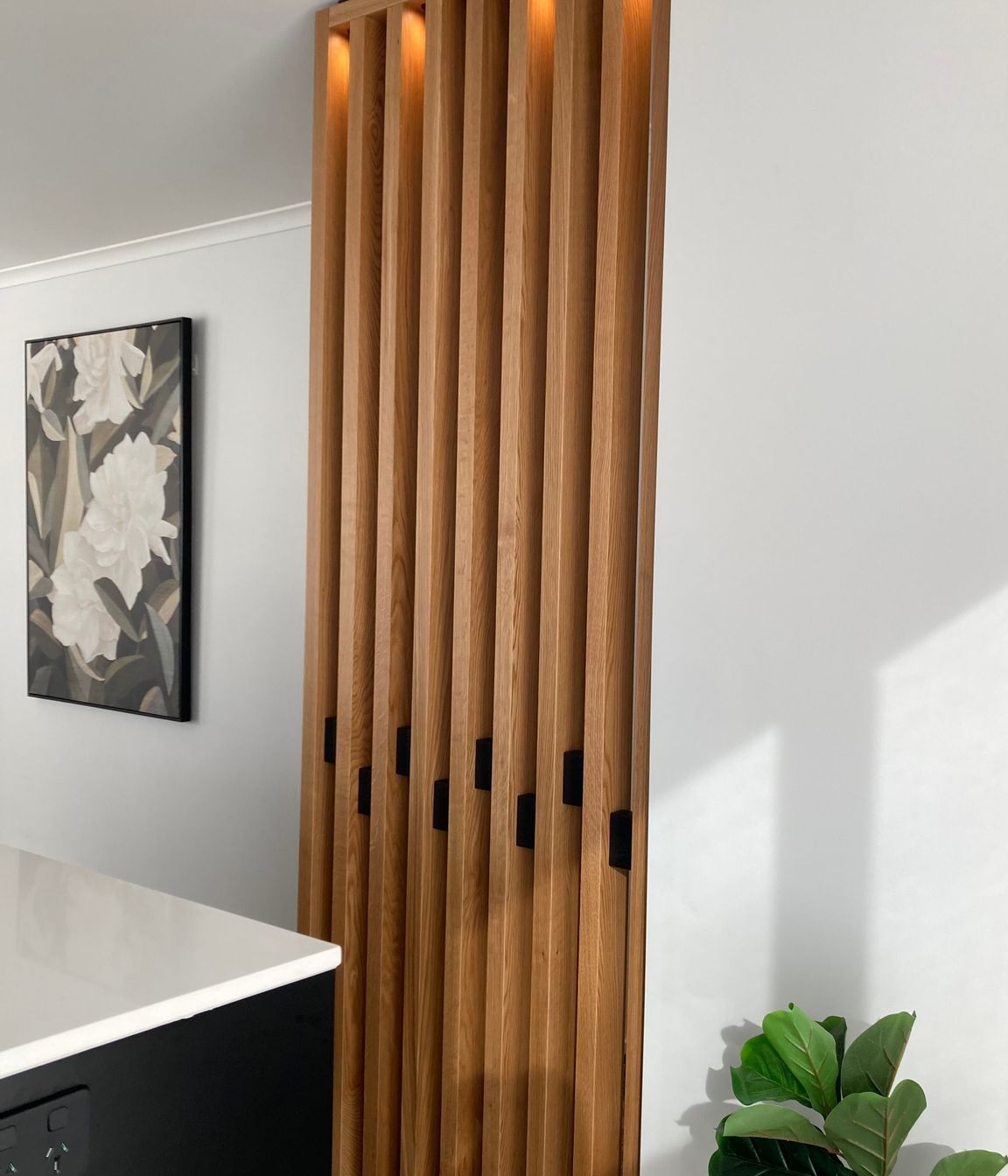 This American oak feature wall has been fitted with down lights to add an element of drama to the space.
