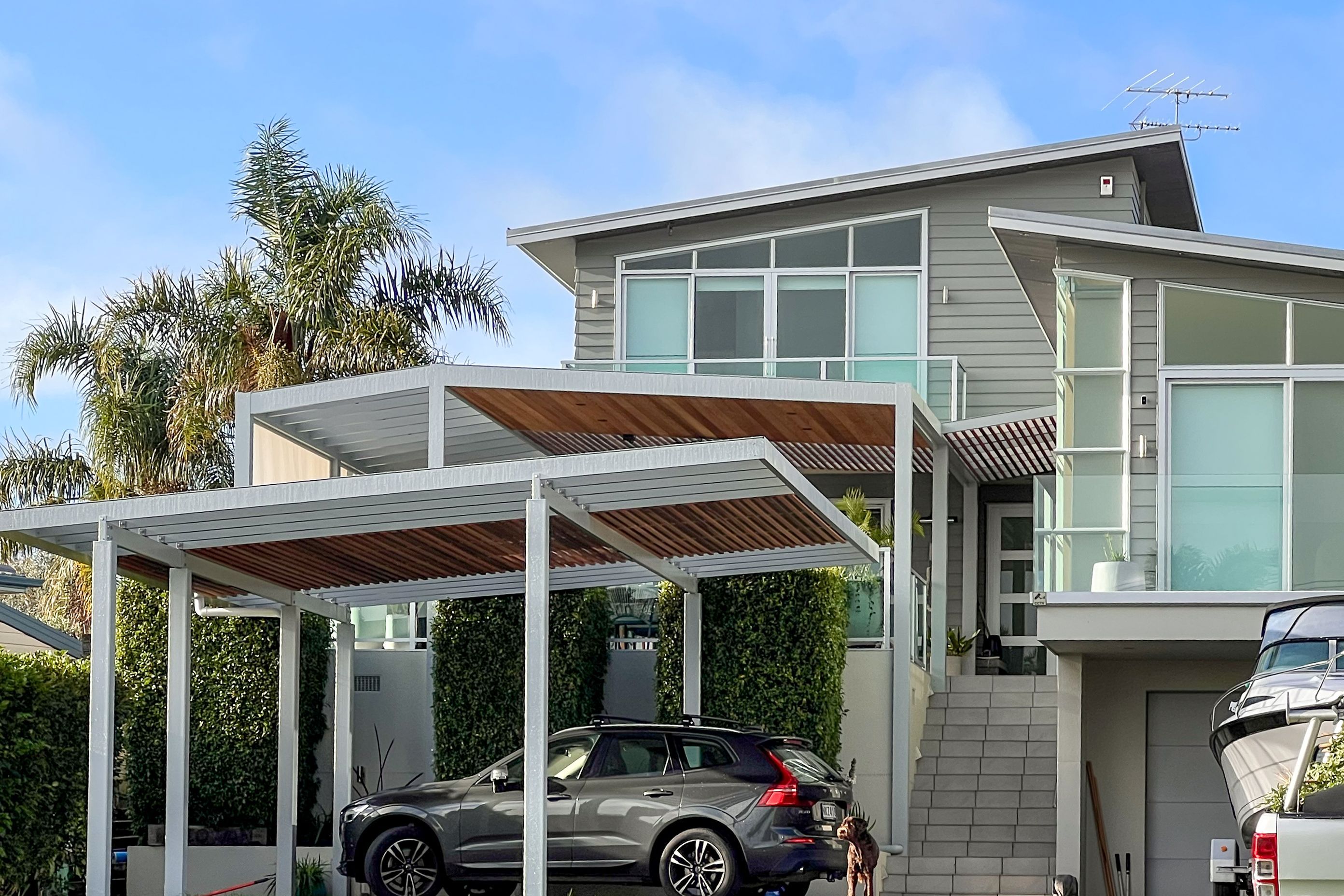 To integrate new pergolas with the design of this home, Sanctuary pergolas created varying pitches that offer architectural continuity. The structures are then softened with timber ceiling cladding and then colour-matched to the home.