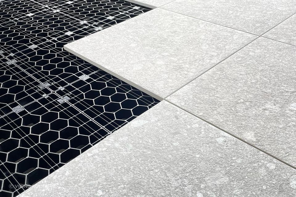 The load-bearing grates clip together to create a foundation for floating decks and tiled or paved landscaping areas.