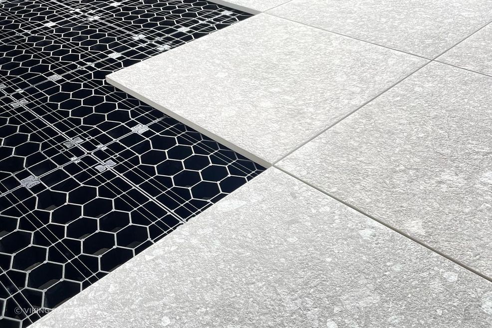 The load-bearing grates clip together to create a foundation for floating decks and tiled or paved landscaping areas.