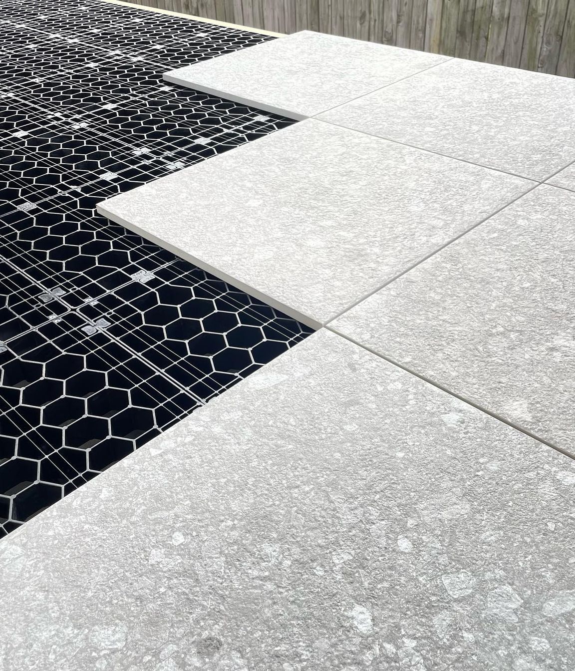 The load-bearing grates clip together to create a foundation for floating decks and tiled or paved landscaping areas.