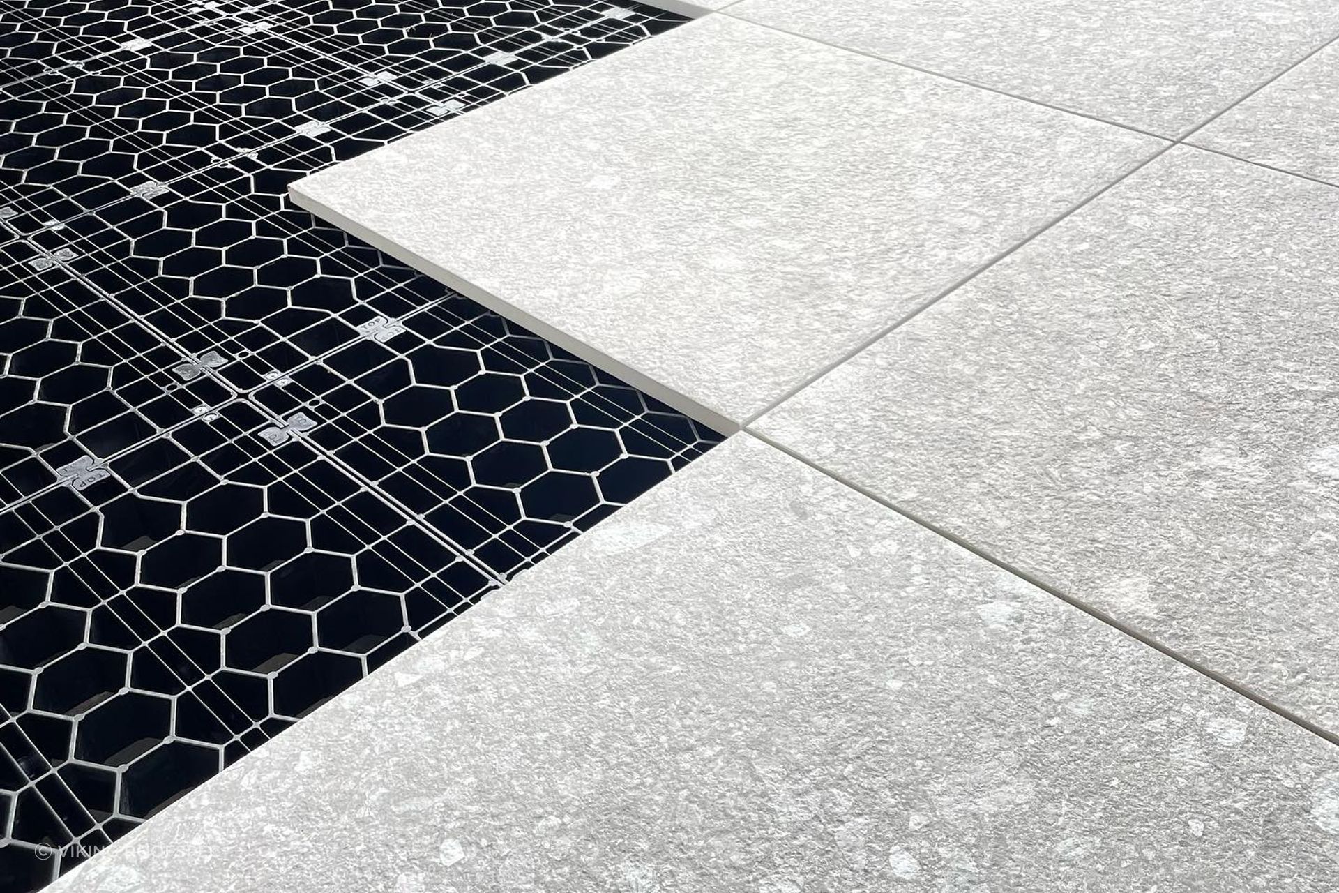 The load-bearing grates clip together to create a foundation for floating decks and tiled or paved landscaping areas.