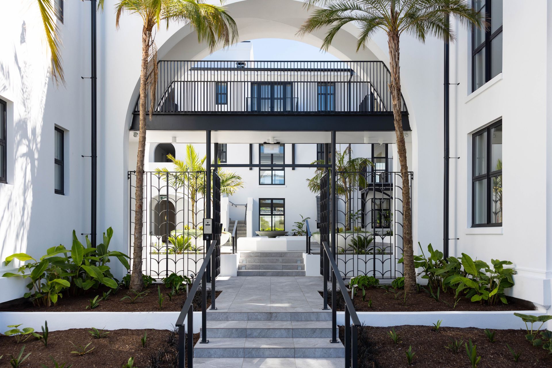 The entranceway of the Arches apartment complex from the street.