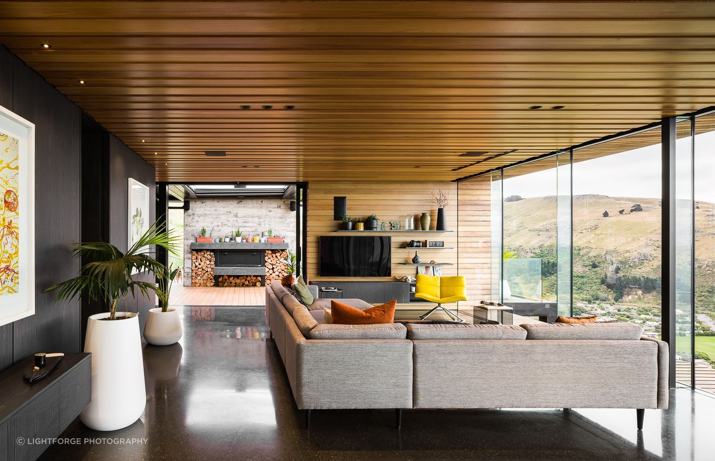 The outdoor fireplace mantel and hearth are coloured the same gloss black as the floors, but using 'natural' and acrylic sealers gives them an entirely different look.