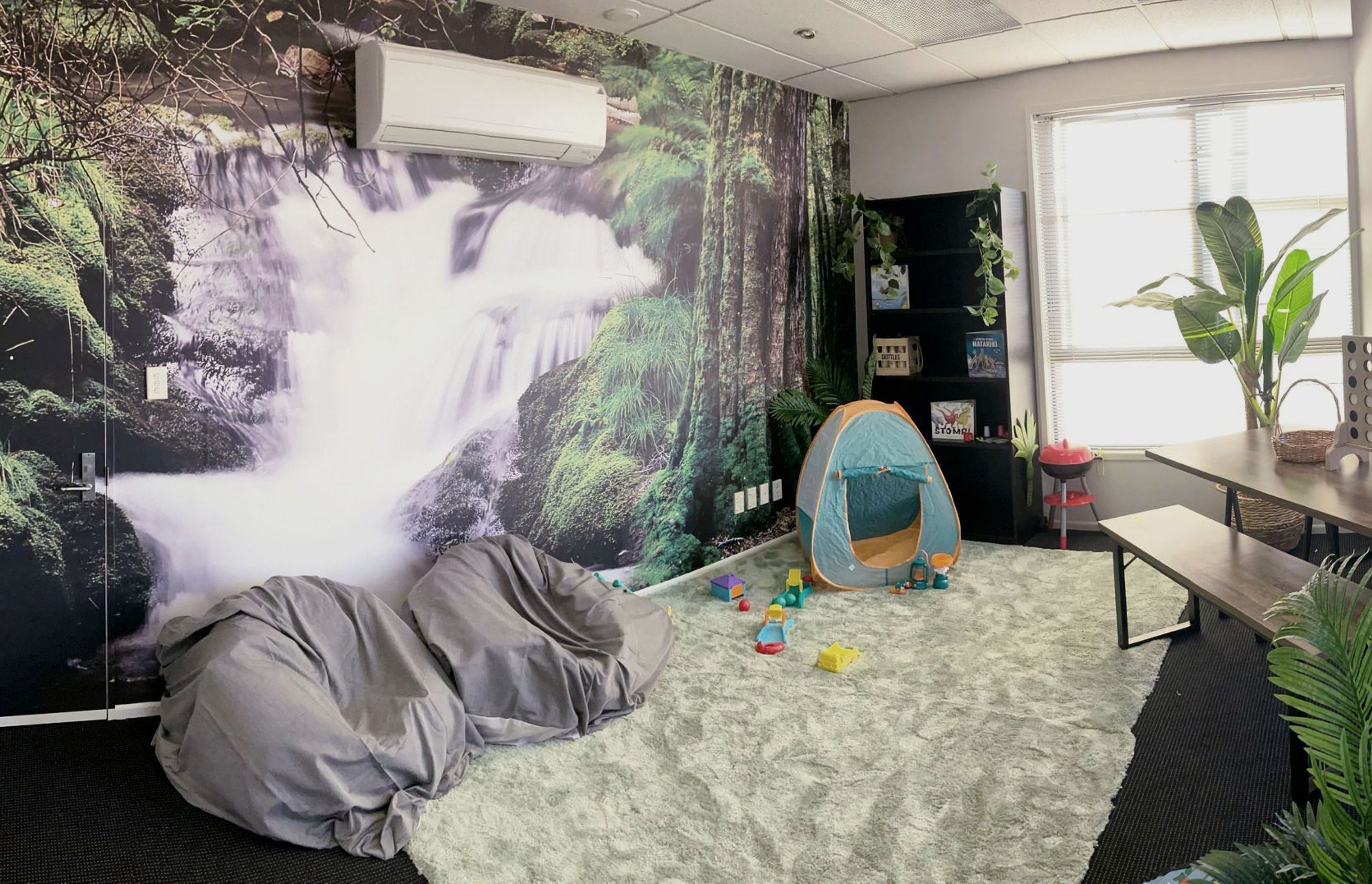 The stunning wallpaper featuring a New Zealand nature scene brings life to a children's play space in the Women's Centre.