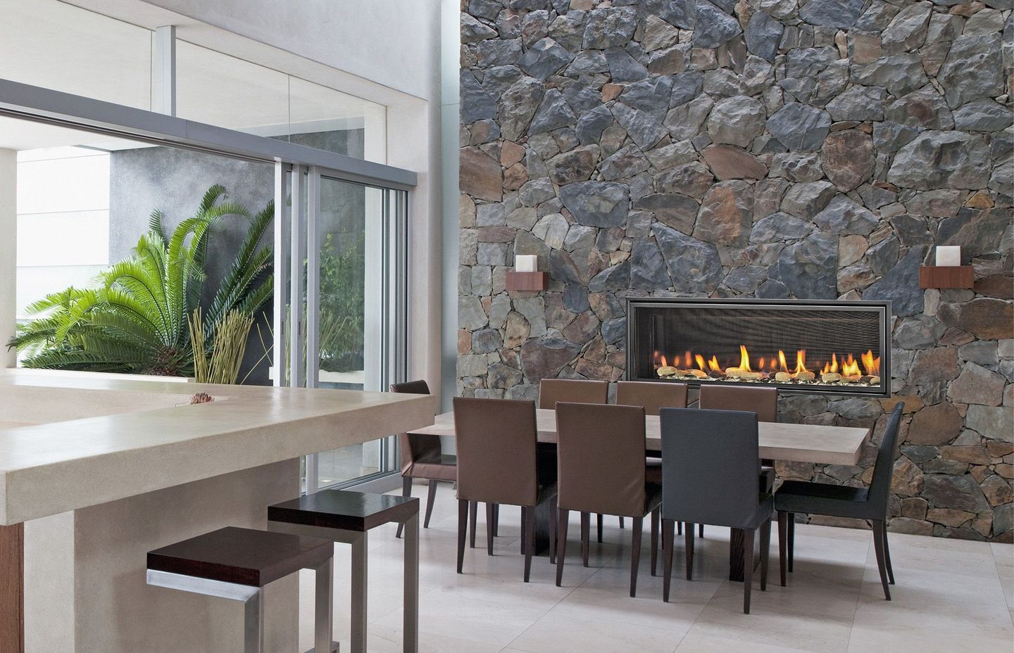 Flames spread across a bed of crushed glass, illuminated by LED underlighting, in the Mezzo fireplace.