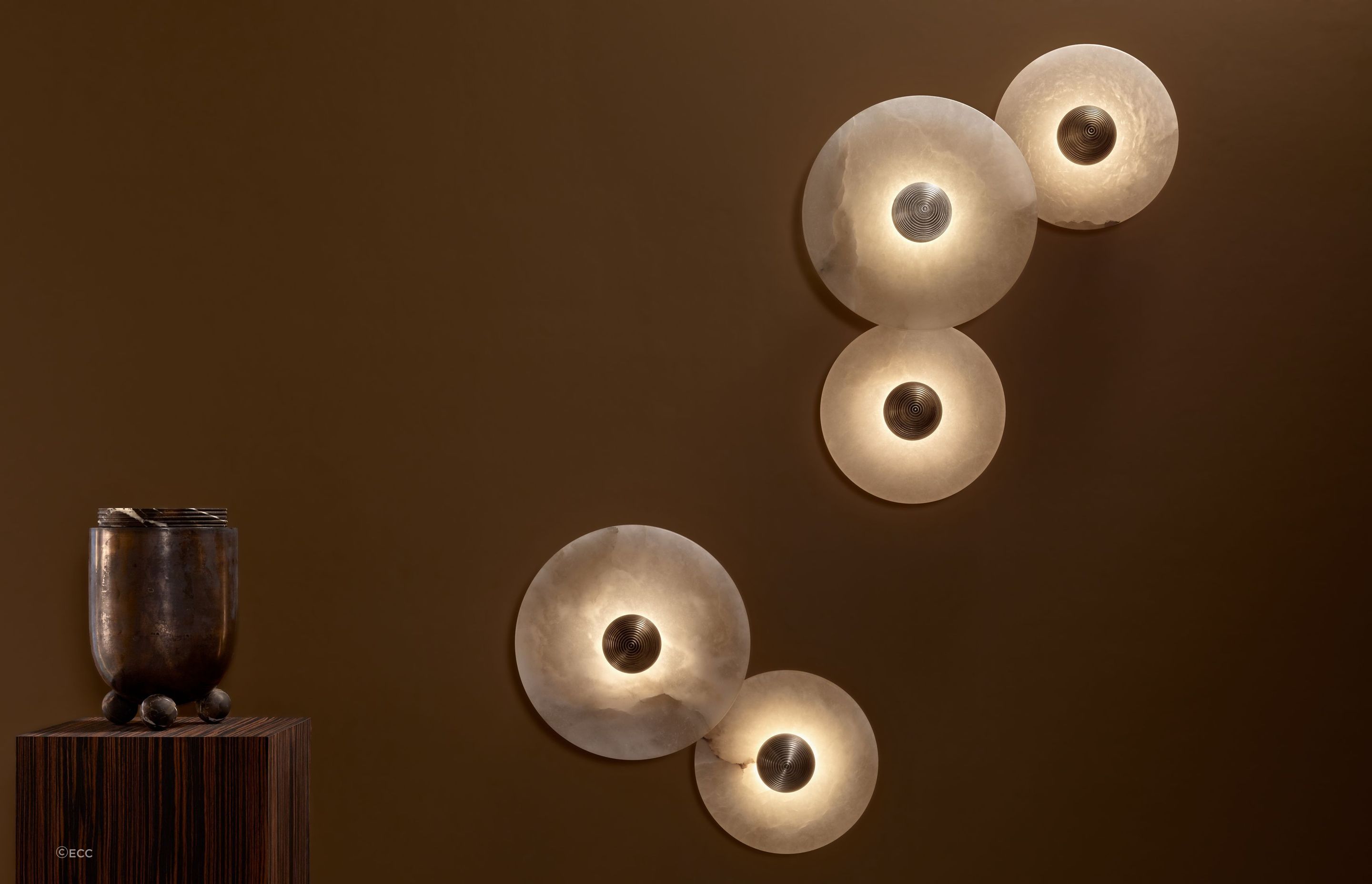 The Median Sconce Wall Light by Apparatus features a stone that glows from a hidden light source adding to its sense of wonder