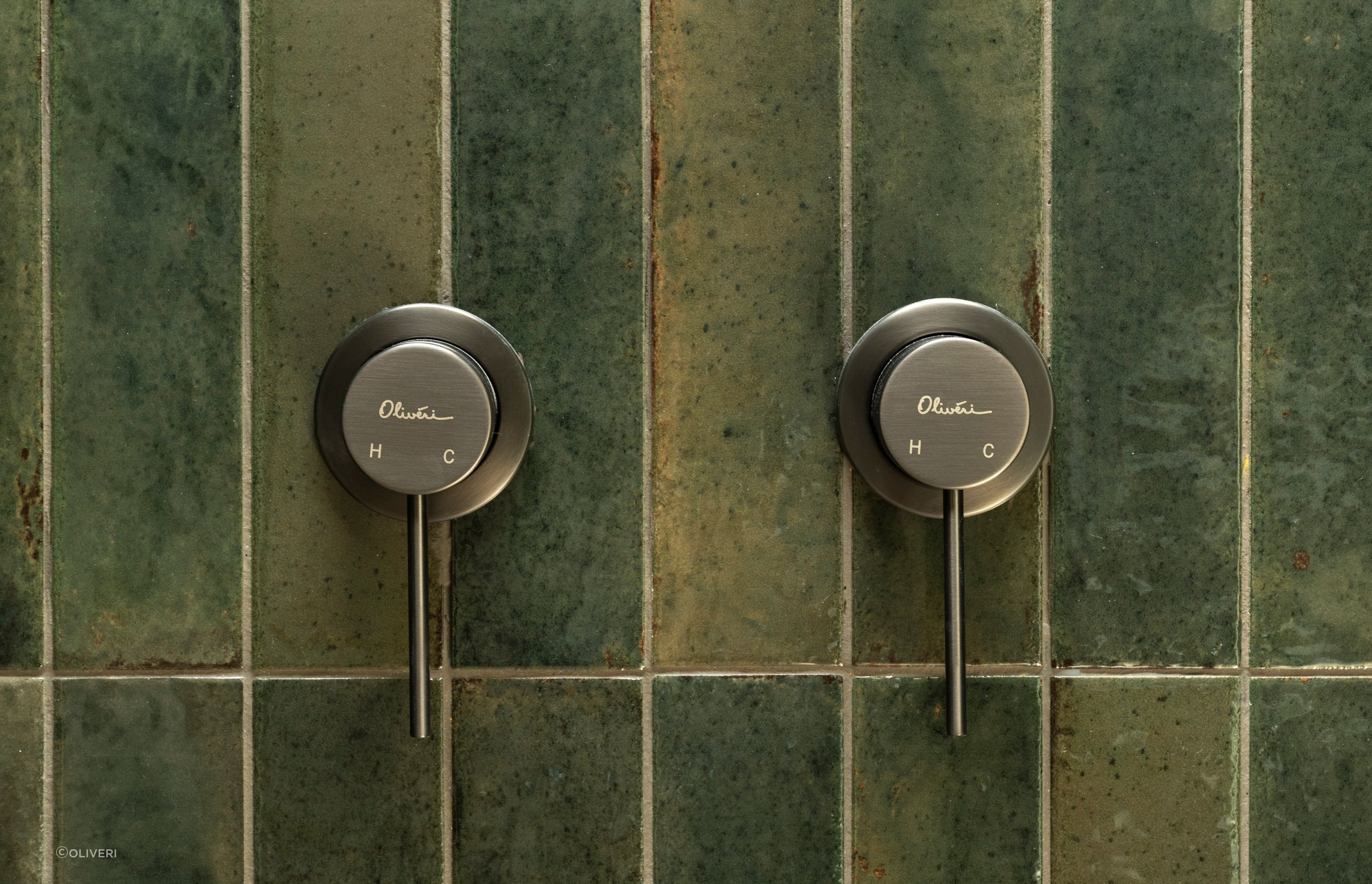 Paired with gorgeous green handmade tiles, Oliver's brushed nickel mixers are ideal for colour-blocking.