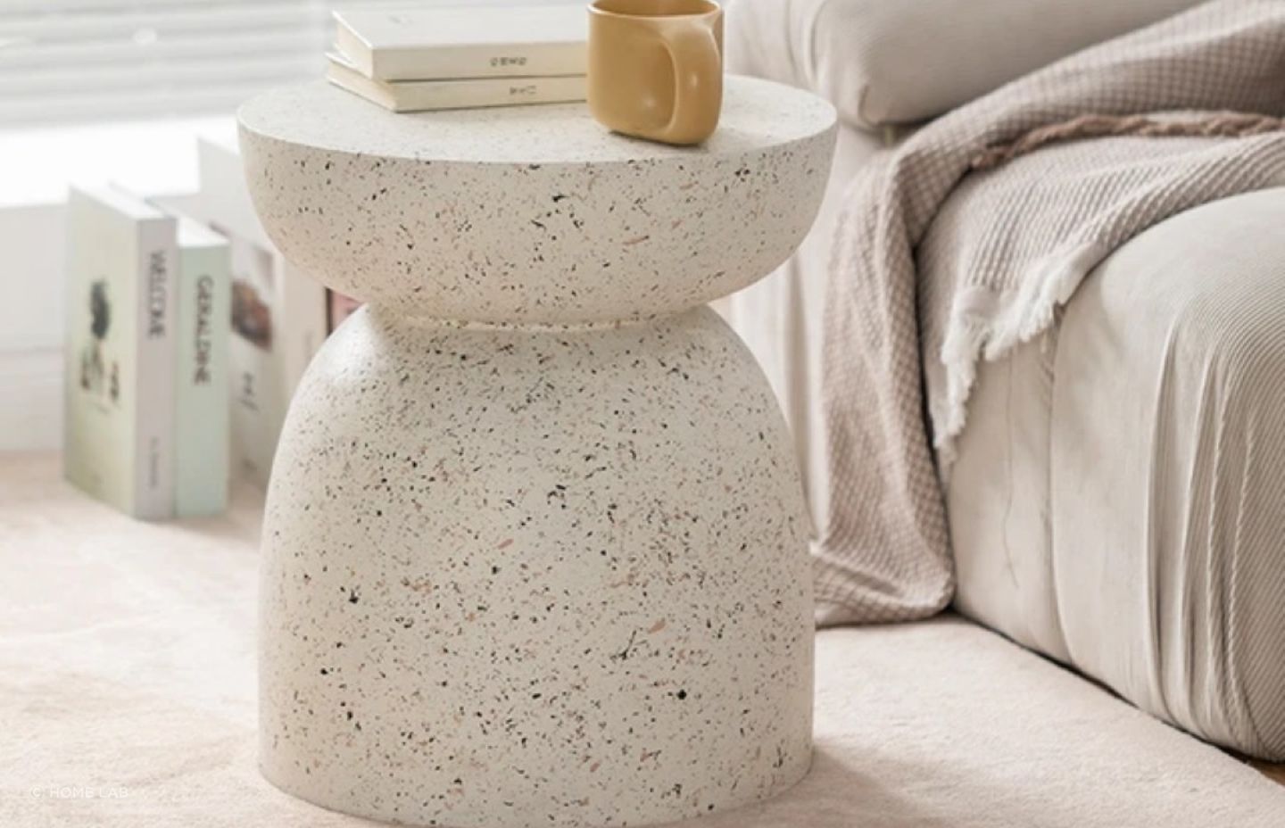 Made from a durable fibre-cement blend, the Pedestal Side Table from Home Lab can be used inside or out.