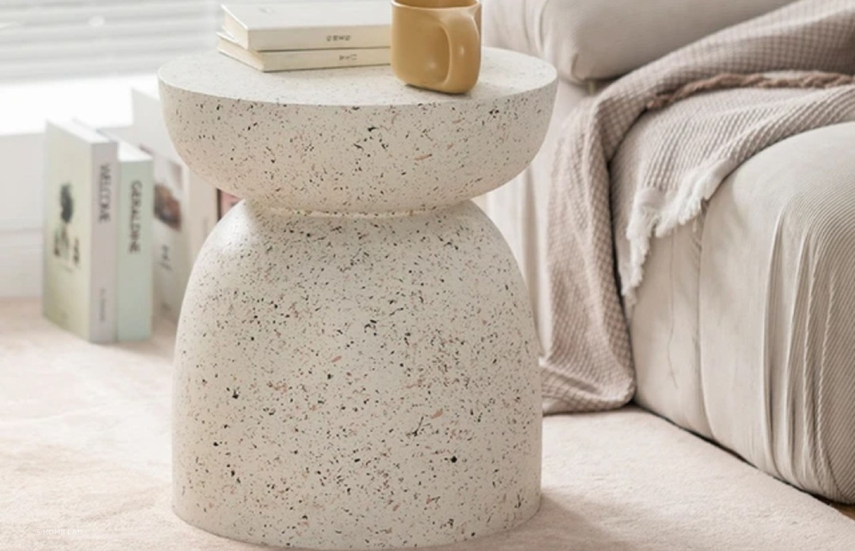 Made from a durable fibre-cement blend, the Pedestal Side Table from Home Lab can be used inside or out.