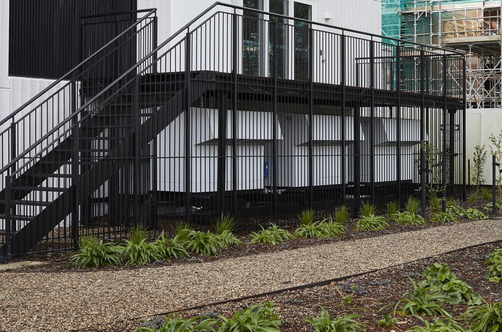 The hot water system units are discreetly located under an external deck.