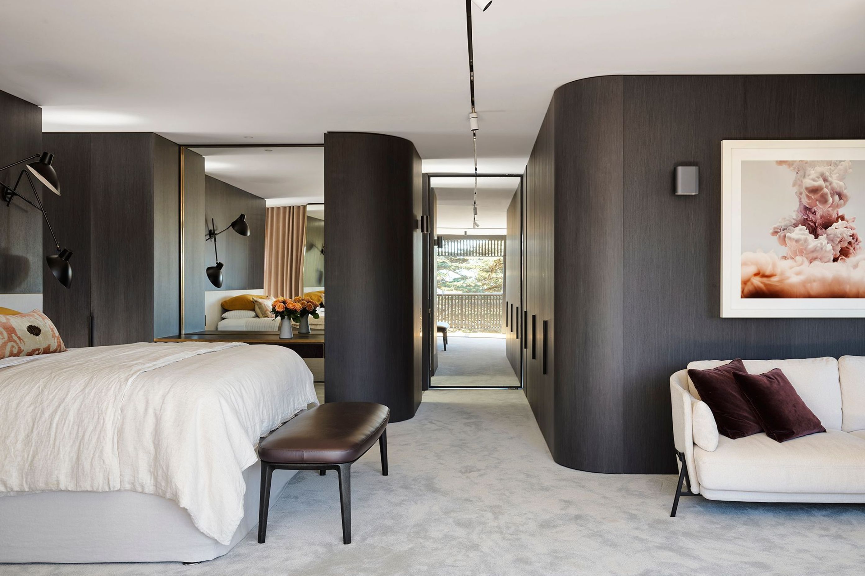 Curved walls soften the main bedroom suite featuring Joseph Giles architectural hardware throughout.