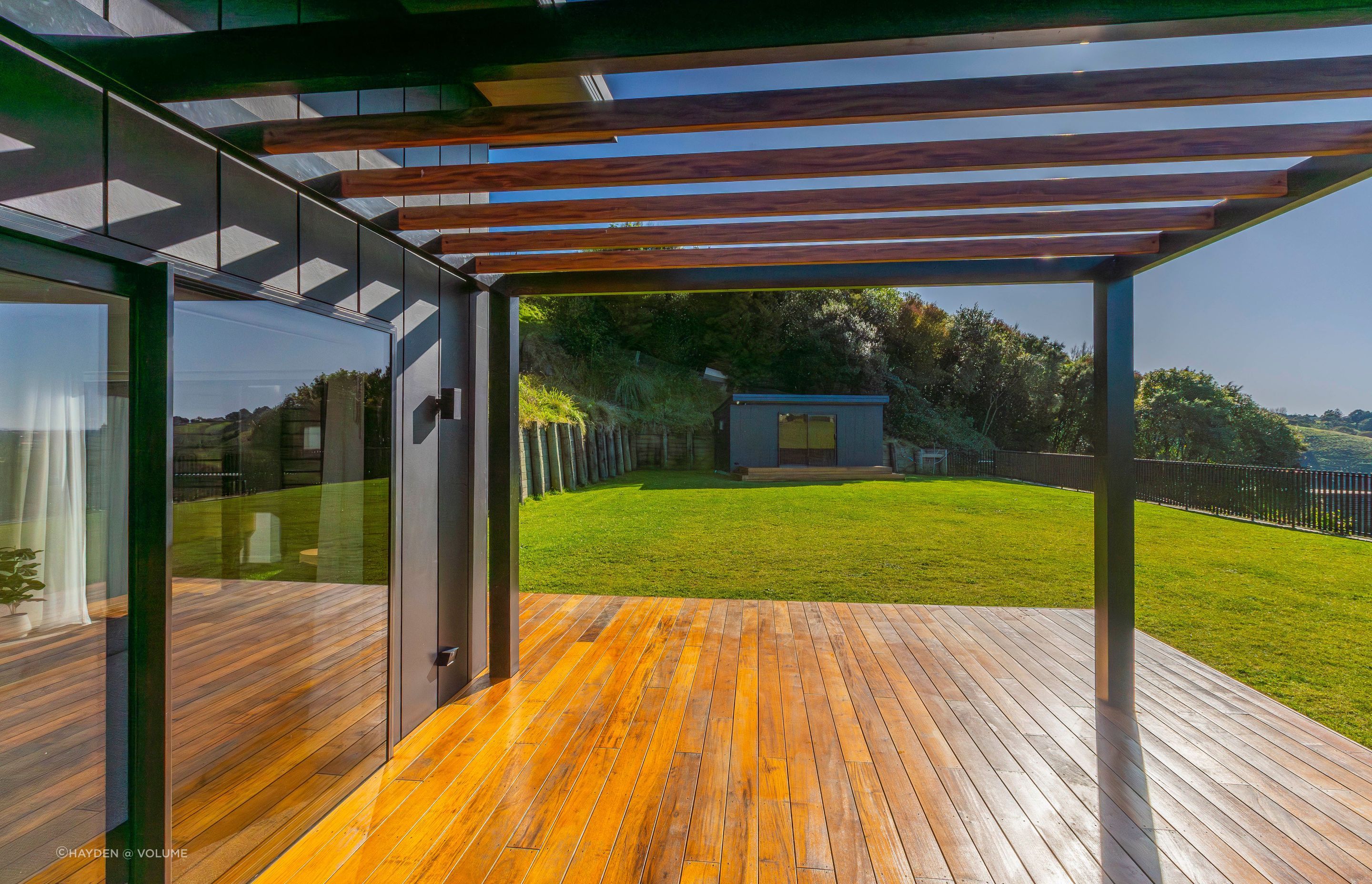 The retaining wall (left) was the crucial first step of the build. The sleep-out can be seen at the end of the lawn.