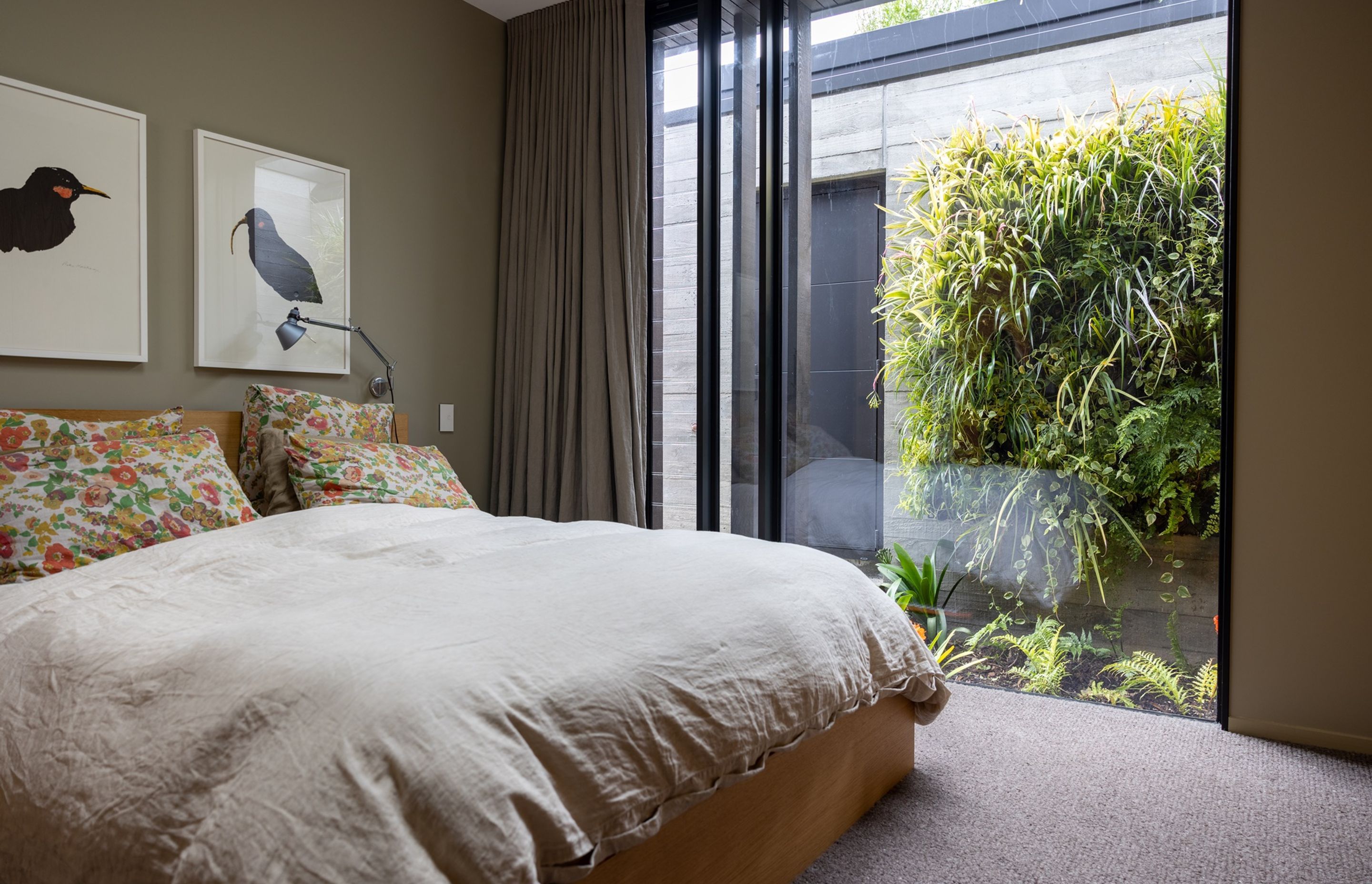 Hidden between the garage and the house, this green wall installed by Natural Habitats can be enjoyed through the bedroom's full-height window – bringing the outdoors in.