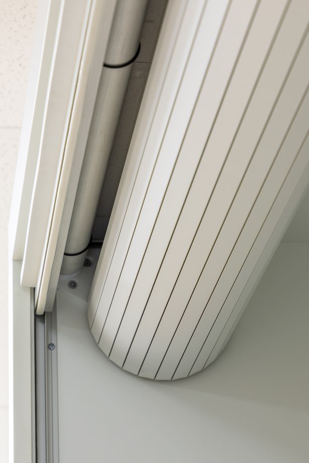 When it is retracted, the roller door is neatly concealed inside the cupboard.