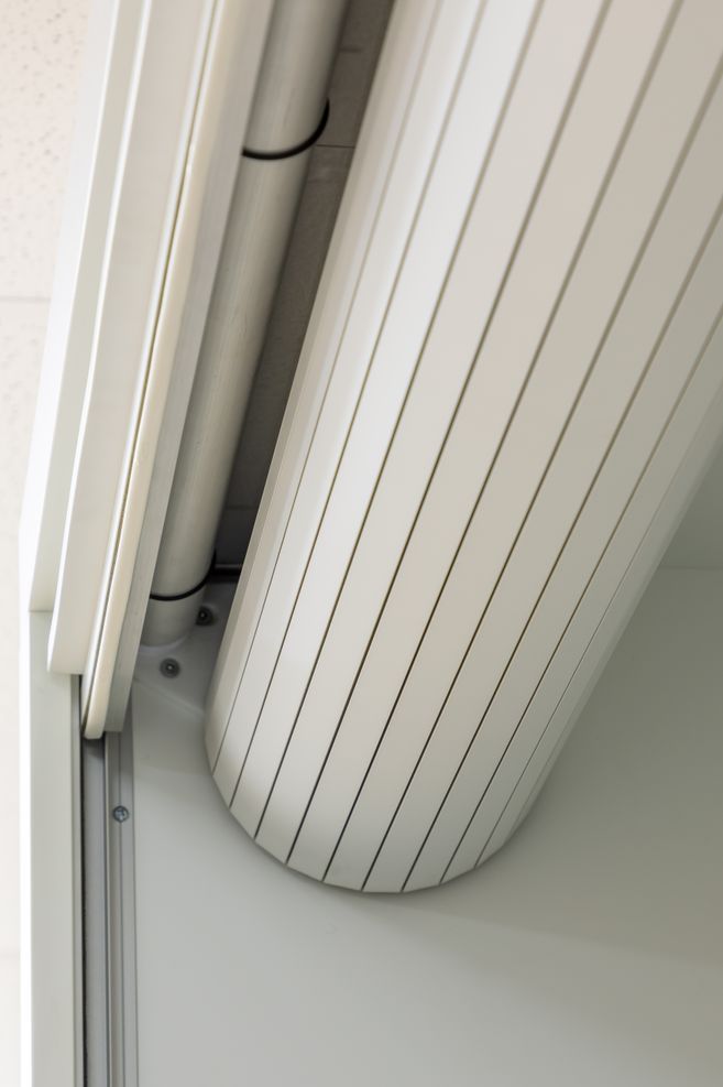 When it is retracted, the roller door is neatly concealed inside the cupboard.