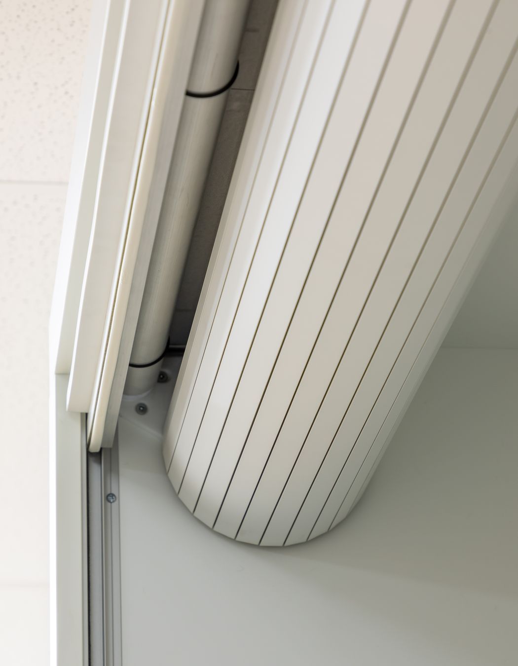 When it is retracted, the roller door is neatly concealed inside the cupboard.