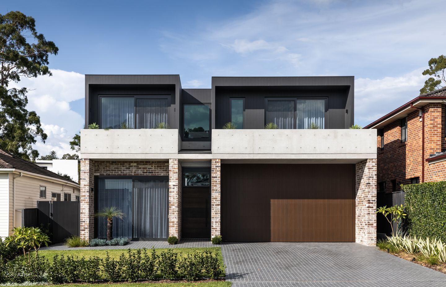 Bespoke recycled brick, off-form concrete and dark timber cladding are skillfully balanced in the exterior of Putney House - Photography: Sebastian Photography
