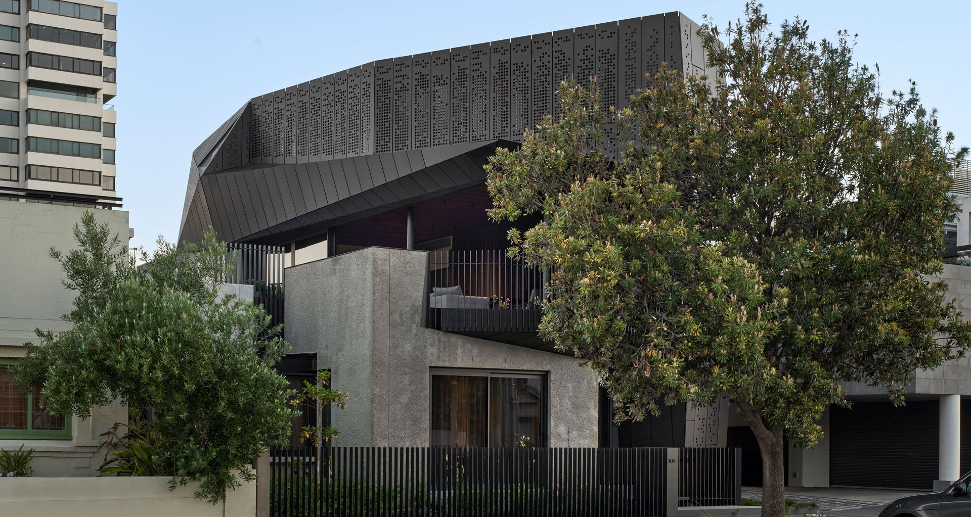 On the upper level of 'Harold' house, the custom motorised perforated aluminium screens by Shade Factor provide privacy and sun shade for the residents. Image credit: Peter Clarke.